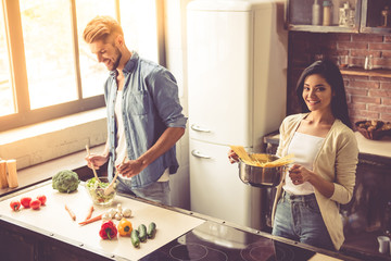 Wall Mural - Young couple in kitchen