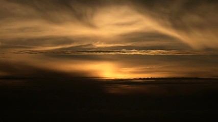 Wall Mural - Beautiful sunrise time lapse on cloudy night with clouds forming into day.