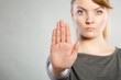 Assertive woman making stop gesture.