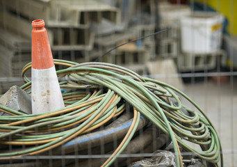 Cone buried between wire at an empty building site