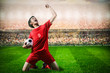 striker soccer football player in red team concept celebrating g