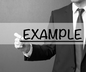 example. businessman in a suit with a marker writing on visual s