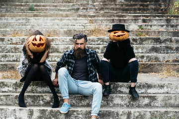 Wall Mural - halloween man and girls with pumpkin