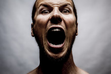 Close Up Portrait Of A Man Shouting, Mouth Wide Open