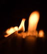 © kiddeephoto - Candles light. Golden light of candle flame.