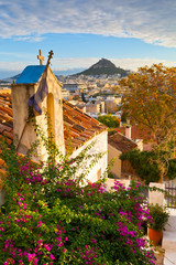 Canvas Print - Lycabettus hill and a small Greek orthodox church in Anafiotika, Athens.