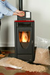 Modern domestic pellet stove with a burning flame