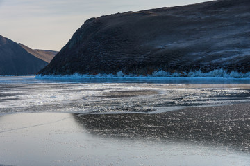 Wall Mural - the first ice on the lake mountains in the background