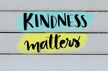 kindness matters inspirational message on grey wooden background