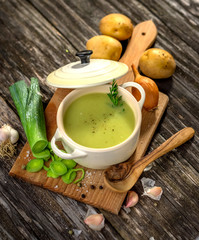 Poster - Homemade creamy leek soup on wooden background