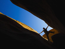 A Male Athlete Exploring Utah Slot Canyons;Hanksville Utah United States Of America