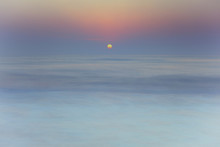 Scenic View Of Sun Rising Over Sea