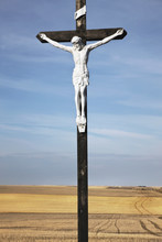 Crucifix And A Farm Field In The Background;Saskatchewan Canada