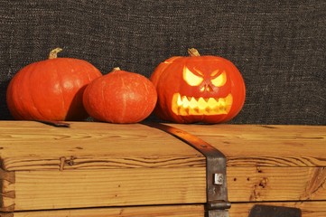 Halloween pumpkins on the wooden coffer