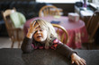 © Designpics - Young girl sitting at the kitchen counter with a cute expression; Surrey, British Columbia, Canada