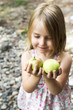 © Designpics - Young girl holding fresh green apples