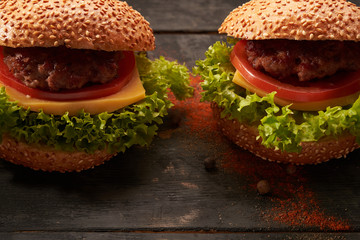 Two hamburger on a wooden table