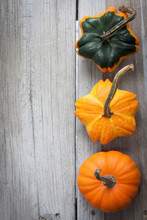 Weathered Wood Background. Three Pumpkins On The Right Side. Copy Space 