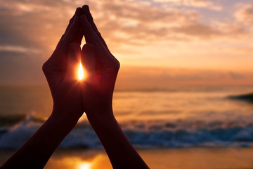 silhouette of female hands during sunset.