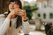 © Jacob Lund - Chinese woman at outdoor cafe with cup of coffee