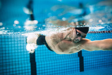 Professional Male Athlete Swimming In Pool