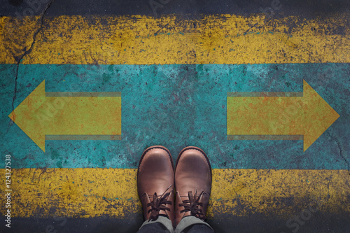 Fotografie, Obraz Top view, Male with Leather Shoes, Arrow Sign on Grunge Dirty Concrete Floor Bac