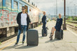© guruXOX - Business people with suitcase posing on the railway station