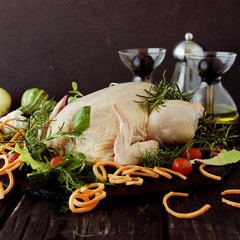 raw chicken with herbs spices ingredients, ready for Christmas