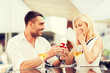 © Syda Productions - happy couple with engagement ring and wine at cafe