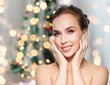 © Syda Productions - woman touching her face over christmas lights