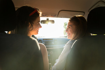 Wall Mural - happy teenage girls or women driving in car