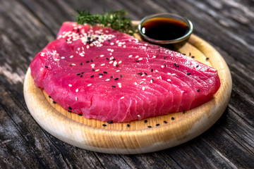 Wall Mural - Raw tuna fillet with soya sauce  on rustic background