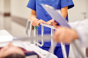 Canvas Print - medics and patient on hospital gurney at emergency