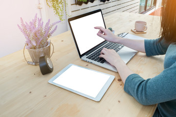 office table with office equipment and woman 's hand touch on bl