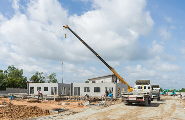 Construction site crane is used to placing precast concrete pane