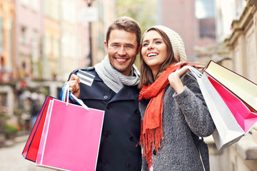 Wall Mural - Happy couple shopping in the city