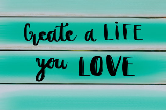 Wall Mural -  - Create a life you love motivational message on wooden painted background