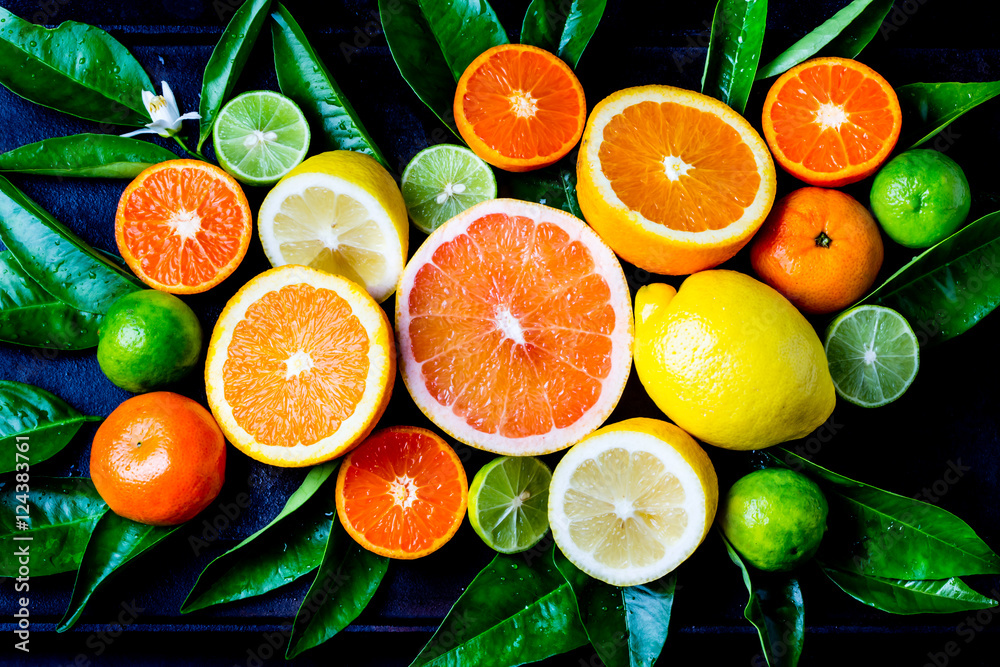 Assorted fresh citrus fruits with leaves - obrazy, fototapety, plakaty 