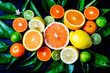 Assorted fresh citrus fruits with leaves