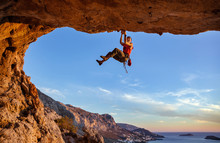 Male Climber Gripping On Handhold While Climbing In Cave. Rock Climbing Without Rope.