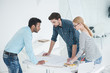 © Yakobchuk Olena - Group of architects discussing plans in modern office