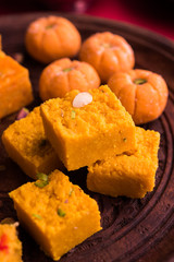 Wall Mural - mango and orange flavoured pedha and burfi, group of indian sweet food or mithai