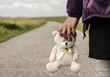 Refugee child goes on the road with her teddy bear