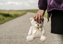 Refugee Child Goes On The Road With Her Teddy Bear