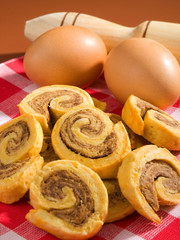 Sticker - Pinwheel cookies with eggs shot over brown background. Vertical