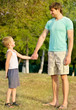 © EVERST - Family Father Man and Son Boy Child holding hand in hand Outdoor Happiness emotion with summer nature on background