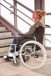 © wernerimages - woman in a wheelchair in front of stairs
