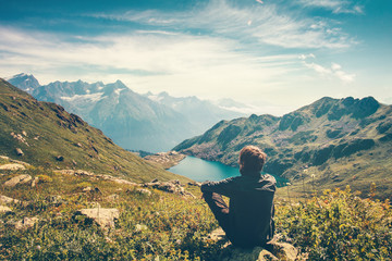 Wall Mural - Traveler Man relaxing meditation with serene view mountains and lake landscape Travel Lifestyle hiking concept summer vacations outdoor