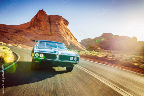 Obraz na plátne driving fast through desert in vintage hot rod car