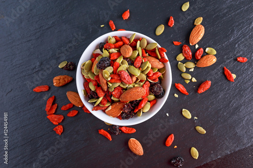 Valokuva Nut mix snack with raisins, pumpkin seeds, almonds and goji berries on stone boa